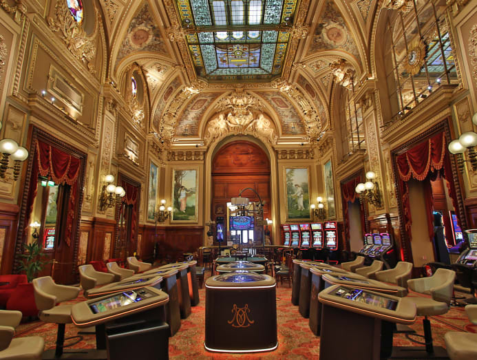 Gaming room inside Casino de Monte-Carlo with roulette and card tables